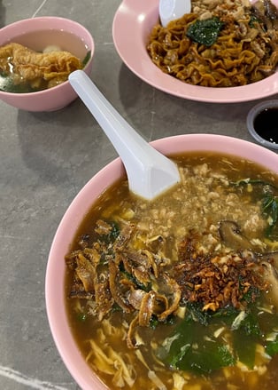 Pan mee, or hand pulled noodles in a gravy sauce and fried anchovies on top
