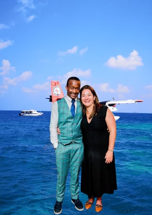 a man and woman standing in front of a plane
