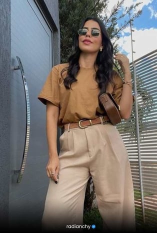 a woman in a tan top and tan pants