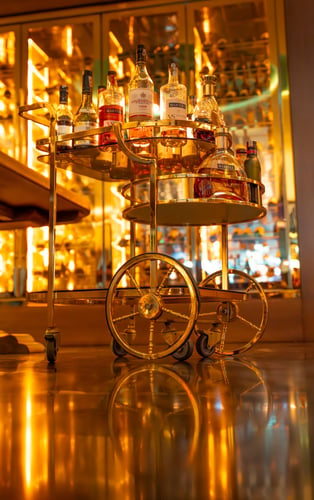 a bar cart with bottles of alcohol and liquor