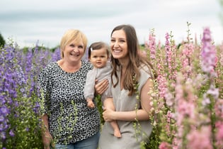 Candid family photo showing 3 generations. Captured by Surrey Family photographer Lauren Gazzard. 