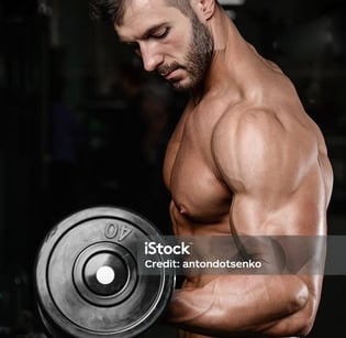 a man with a dumbbell in his hand
