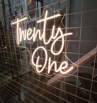 Twenty One neon sign lit up to match the gold theme at Kaea's 21st birthday party in Brisbane.