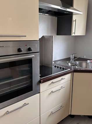 a kitchen with a stove top oven and a sink