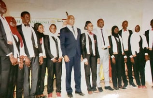 a group of men and women in suits and ties on a stage