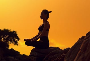woman meditating on rock with sunset background