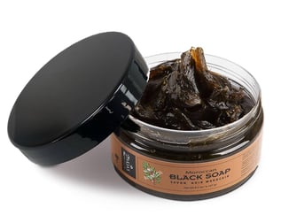 a jar of black soap with a black soap