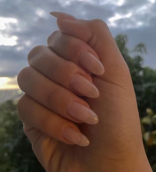 hand showing nude pink manicure, natural looking manicure