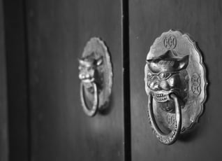 A Chinese door knocker with a lion head on it