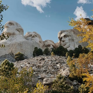a mountain top with a view of mount rushmore in the background