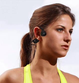 a woman in a yellow top and black earphones