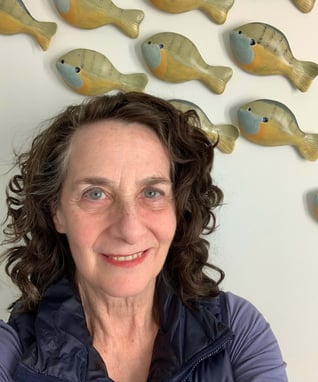 Jane Freidson with ceramic fish on the wall