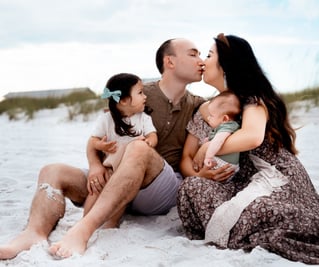 a family of four sitting at Henderson Beach, Florida