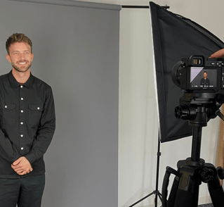 a man in a black shirt and a camera