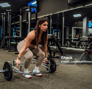 a woman using a trap bar for exercise 