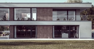 a house with a balcony and a car parked in front of it