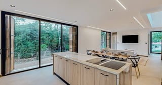 a kitchen with a large window and a table with chairs