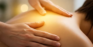 Reiki practitioner giving an energy healing session on a client’s back