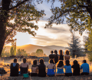 a group of people sitting on a hill