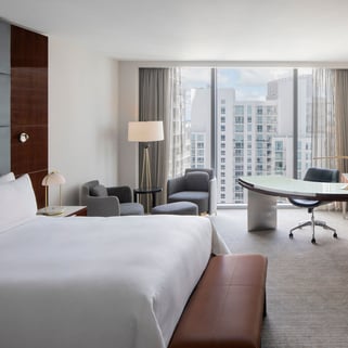king bed and desktop in JW Marriott Marquis Miami with miami in the background through the window