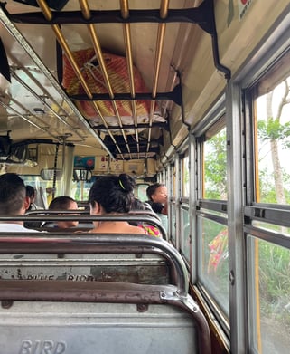 People sitting inside a local bus, known as a chicken bus, in Guatemala.