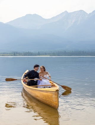 a eloping couple in a canoe on a lake