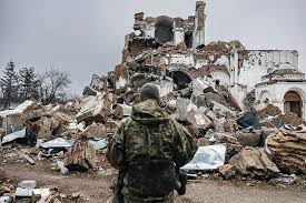 a soldier lokking at destruction during war