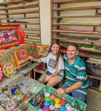 a man and woman sitting on a bench in a room