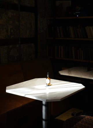 a small table with a bottle of wine on it