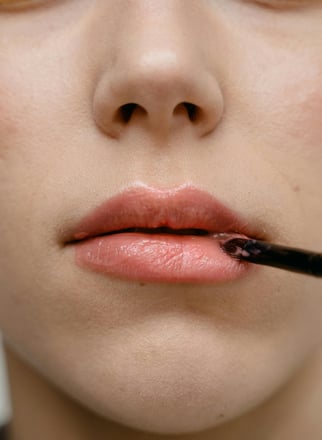 a woman applying lipstick