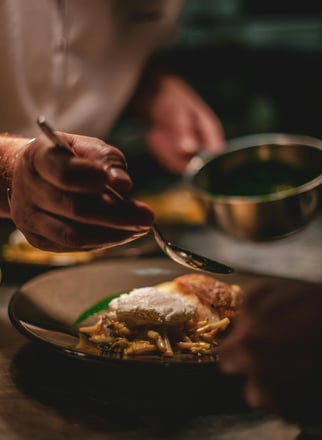 a person is presenting food on a plate