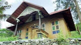 a house with a stone wall and a stone wall