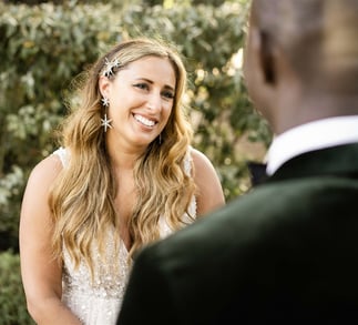 Bride smiling at groom during outdoor Provence elopement ceremony, captured by fine art wedding phot