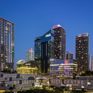 view of the east hotel in miami from brickell city center with the sky in the background on a sunset with bright lights from 