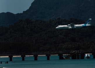 a plane taking off from a beach
