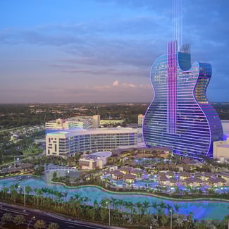 aerial view of the Seminole Hard Rock Hotel and Casino at dusk with the sky and the city of Mimai in the background