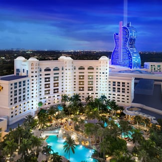 aerial view of the Seminole Hard Rock Hotel and Casino at dusk with the sky and the city of Mimai in the background