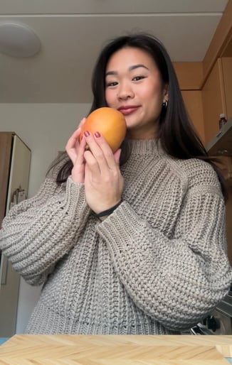 woman holding a mango