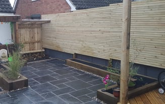 log store, bench, privacy screens sleeper beds and limestone paving