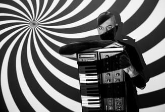 a man with a beard and a beard, holding a piano and a keyboard