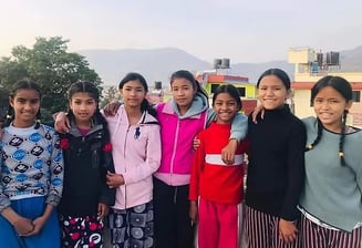 a group of girls standing on the top of her house