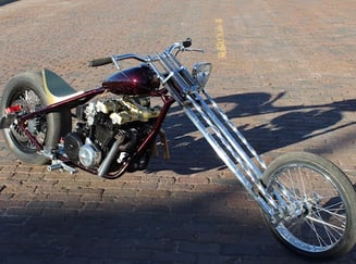Custom motorcycle parked on brick road