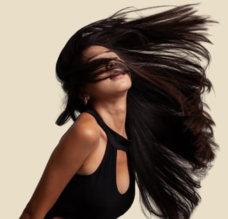 a woman with long hair and a black dress