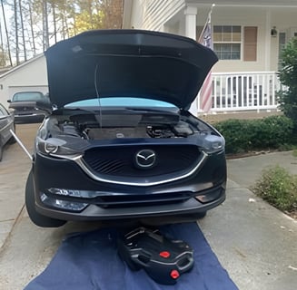 image of car with oil pan under it