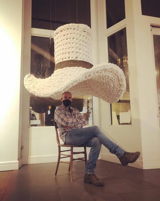 Ken Chapin sits beneath a six foot crocheted cowboy hat "Tom Mix Wept" @ BRDG Project's "True West"