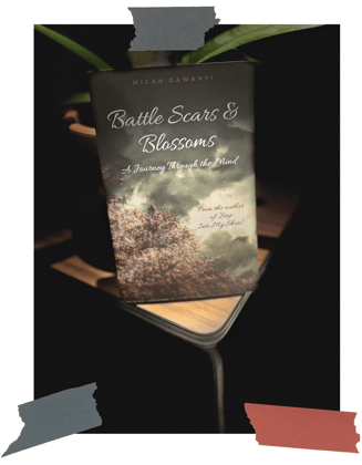 Battle Scars & Blossoms book on desk by Micah Dawanyi