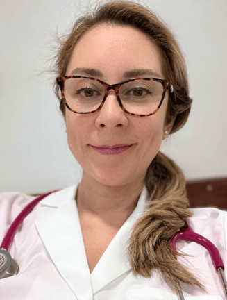 a woman in a white lab coat and glasses