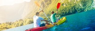 a man and woman are kayaking in a kayak