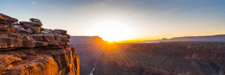 a sunset over a canyon