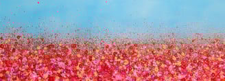 a field of red flowers with a blue sky in the background
